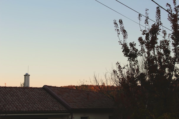 A beautifully restored rooftop overlooking a serene natural landscape at sunset.