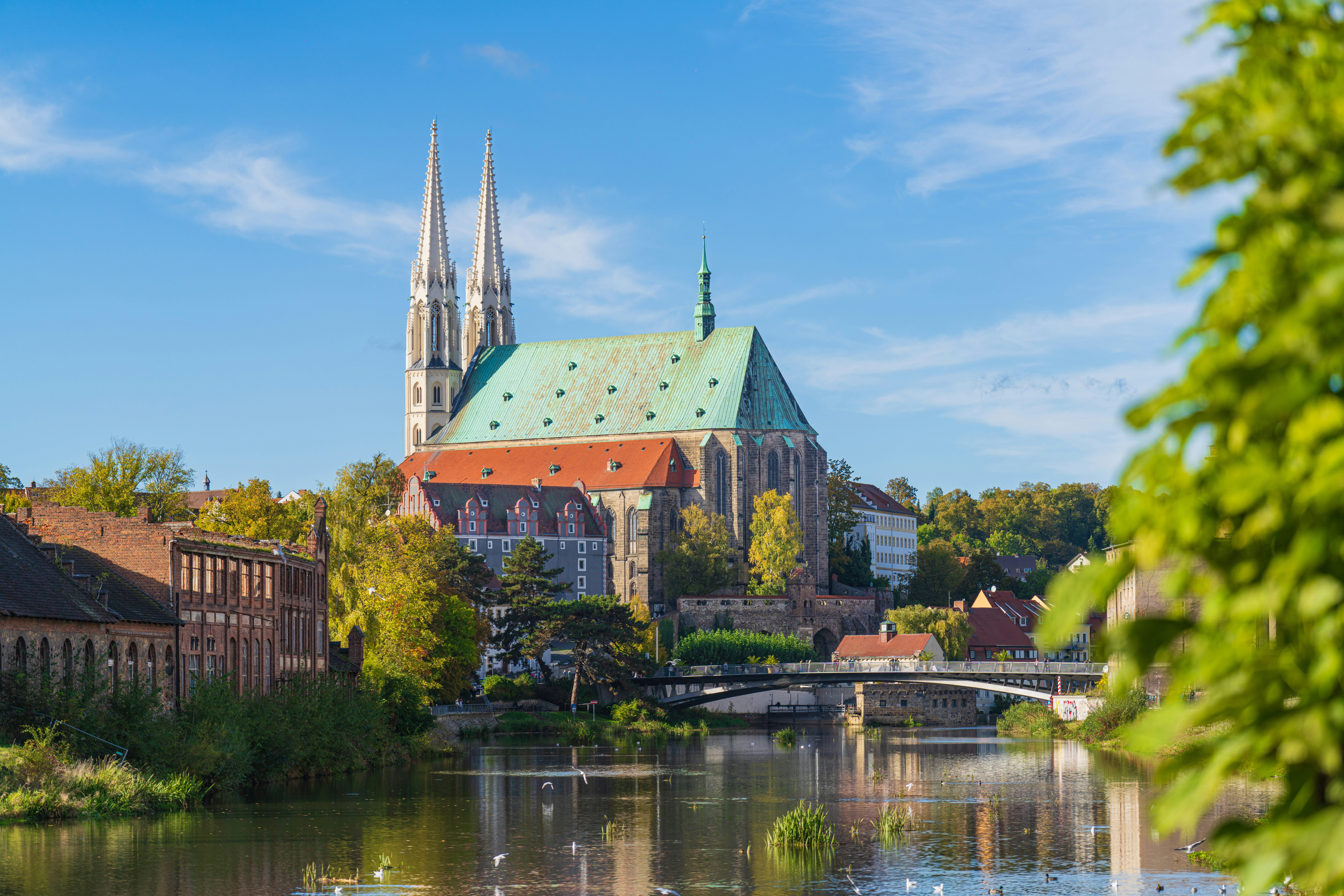 a large cathedral towering over a city next to a river