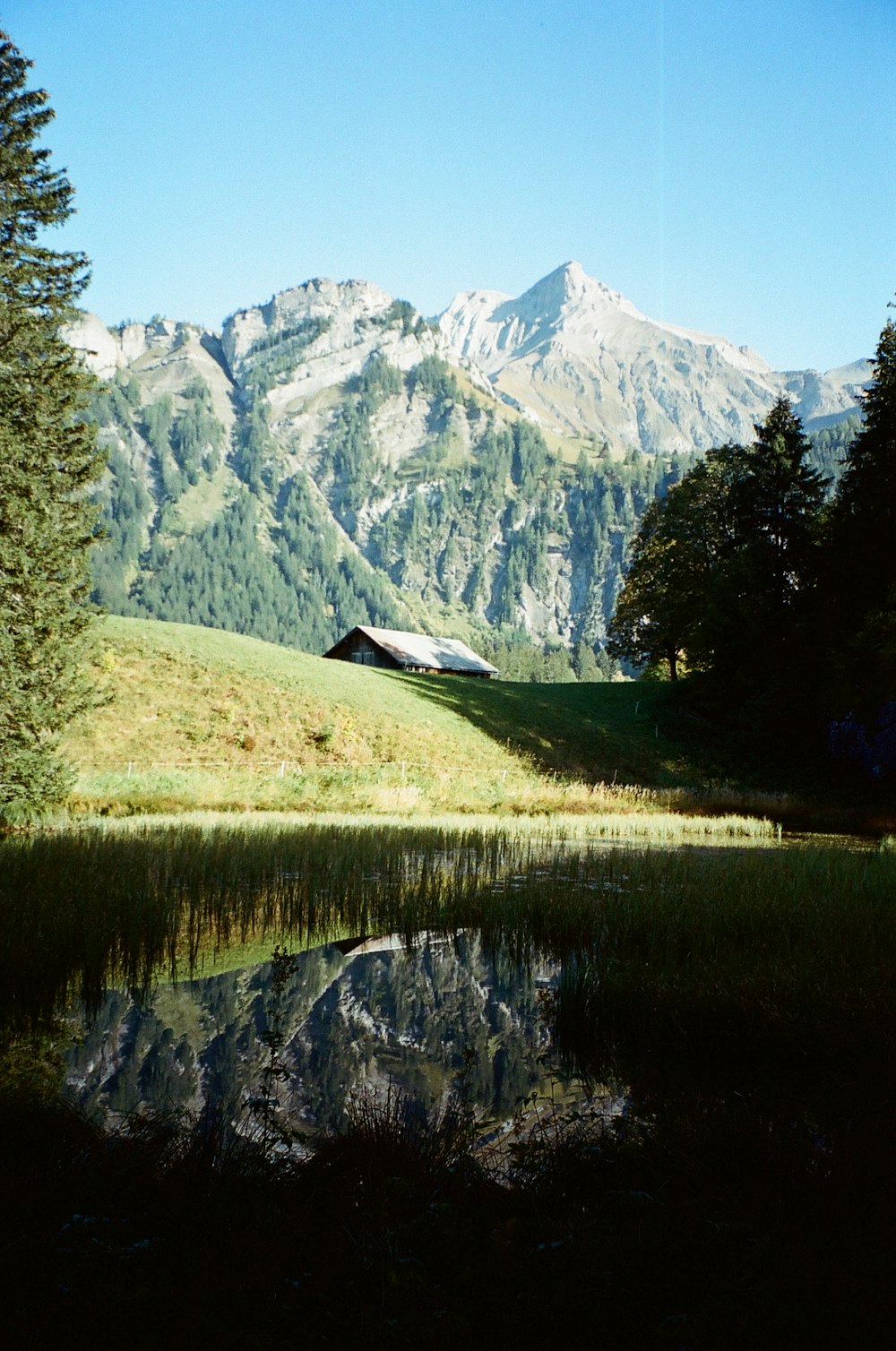 a mountain range with a lake in the foreground