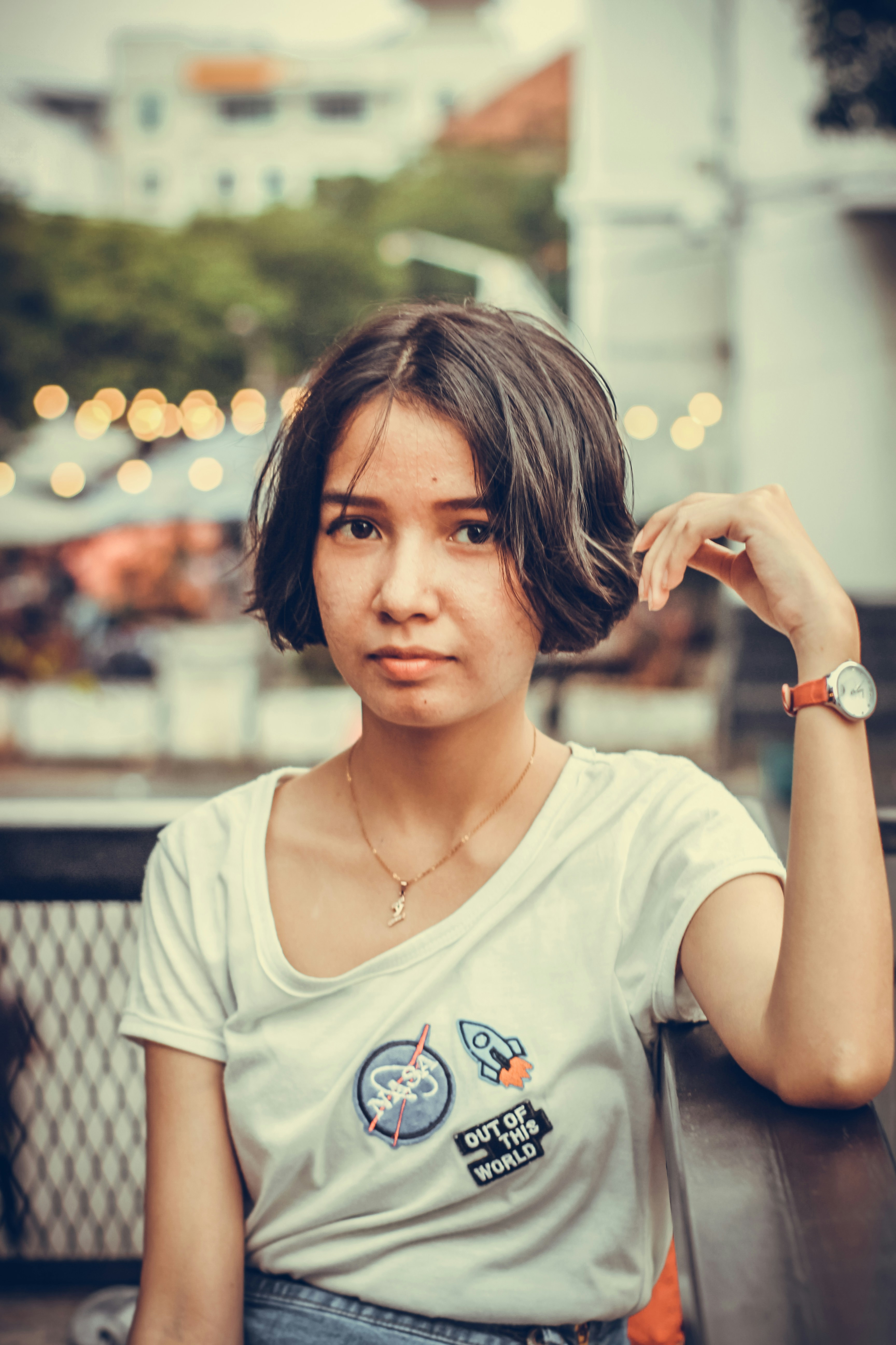 a woman sitting at a table with a watch on her wrist