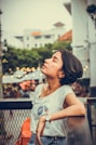 a woman sitting on a bench looking up
