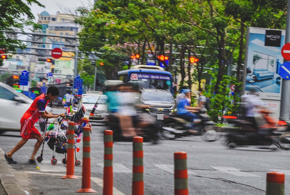 a man walking down a street next to traffic cones