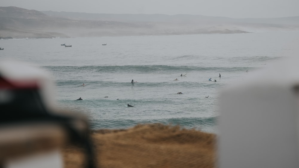 a group of people in the ocean on surfboards