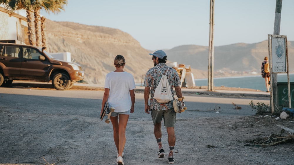 a man and a woman walking down a dirt road