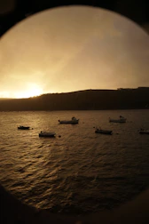 Sunset view over Bayahibe harbor with fishing boats and calm sea.