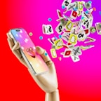 Colorful icons representing likes and hearts floating around a phone.