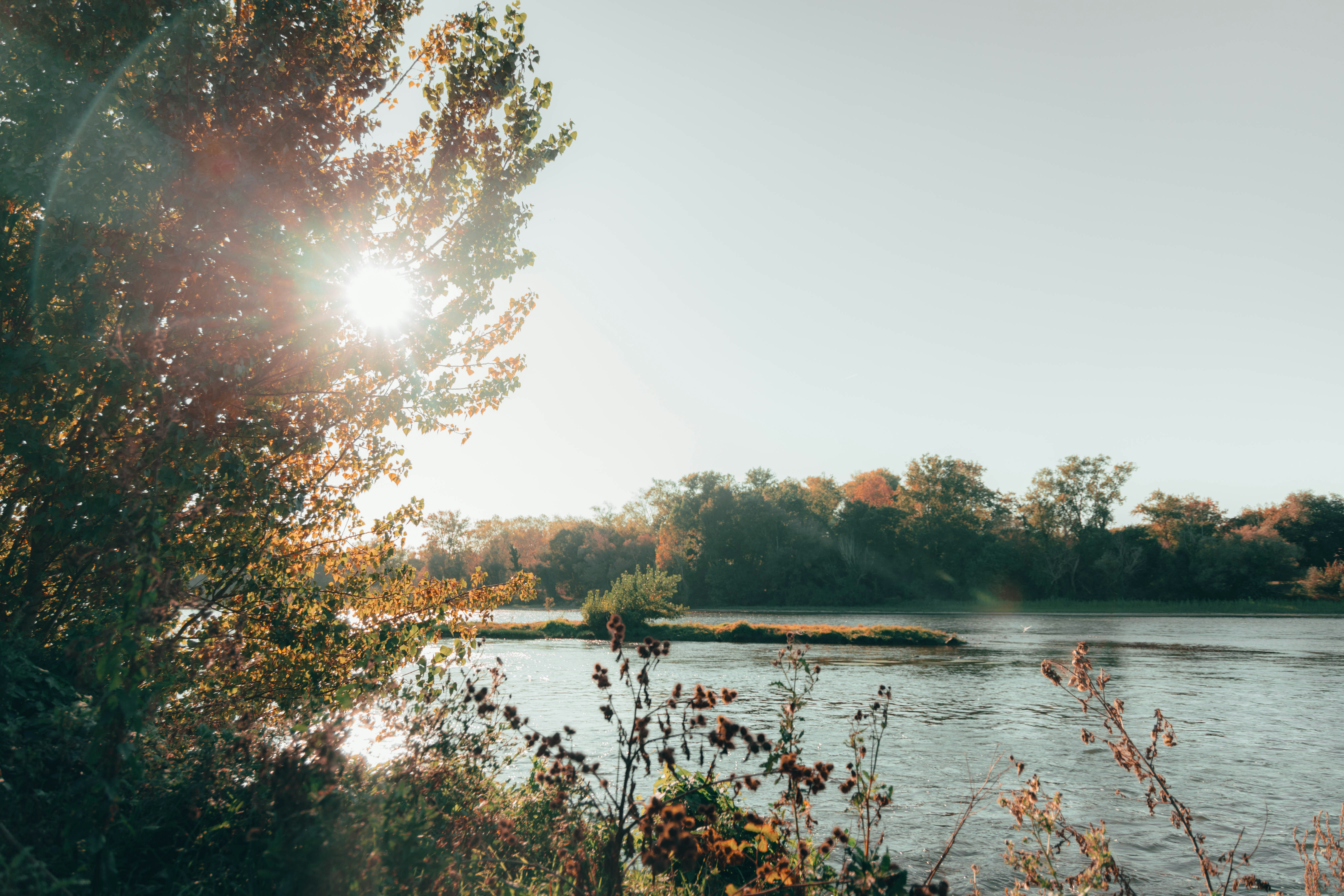 the sun shines brightly over a body of water