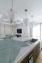 Wide shot of a spacious kitchen island featuring a quartz countertop with a waterfall edge.