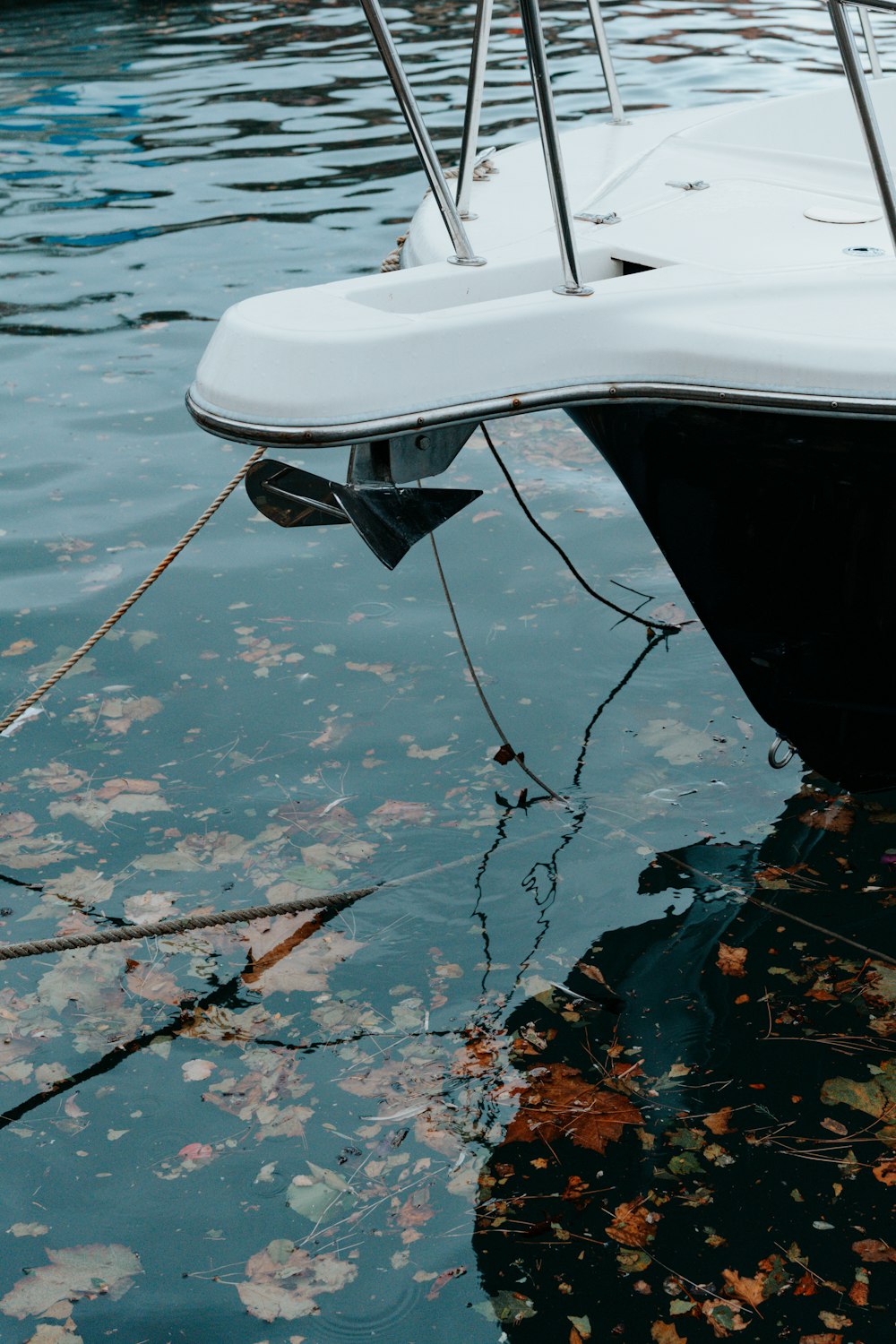 a white boat floating on top of a body of water