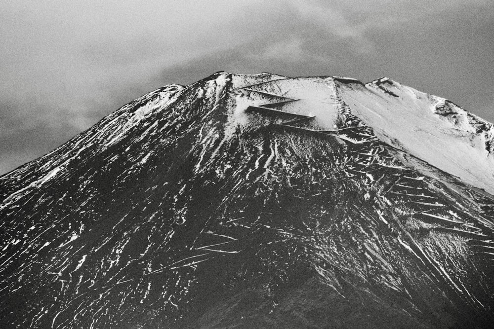 a black and white photo of a snow covered mountain