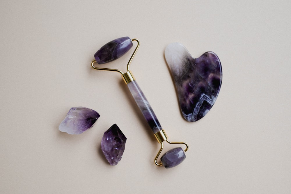 a pair of scissors and some amethysts on a table