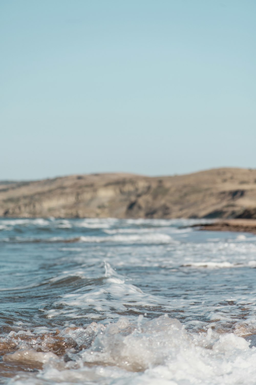 a person riding a surfboard on top of a wave