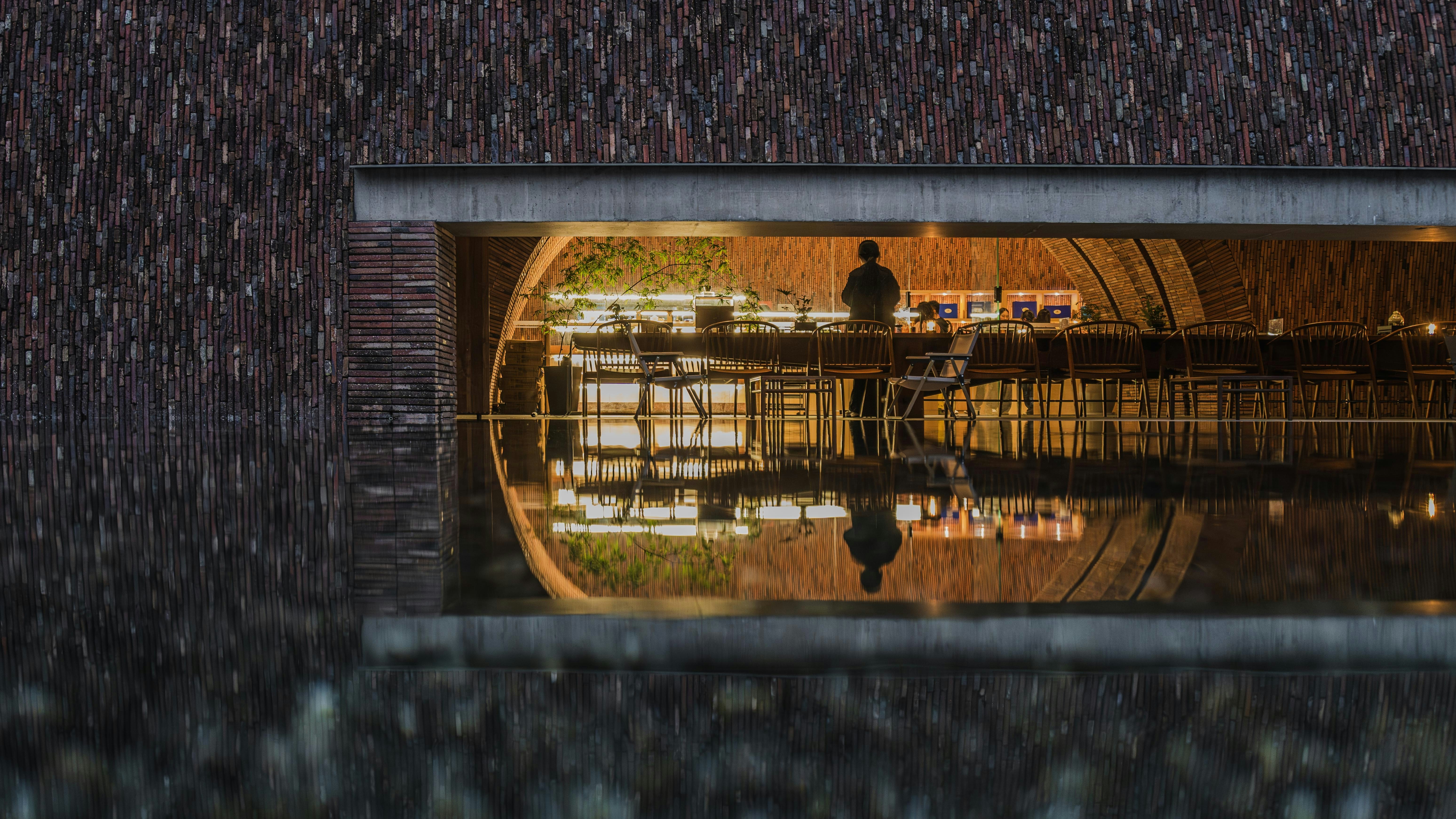 a reflection of a man standing in a restaurant