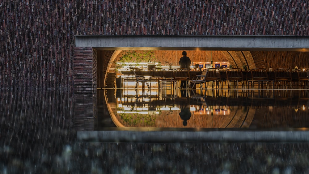 a reflection of a man standing in a restaurant