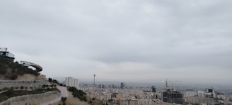 A panoramic view of a modern industrial township under development with cranes and buildings.