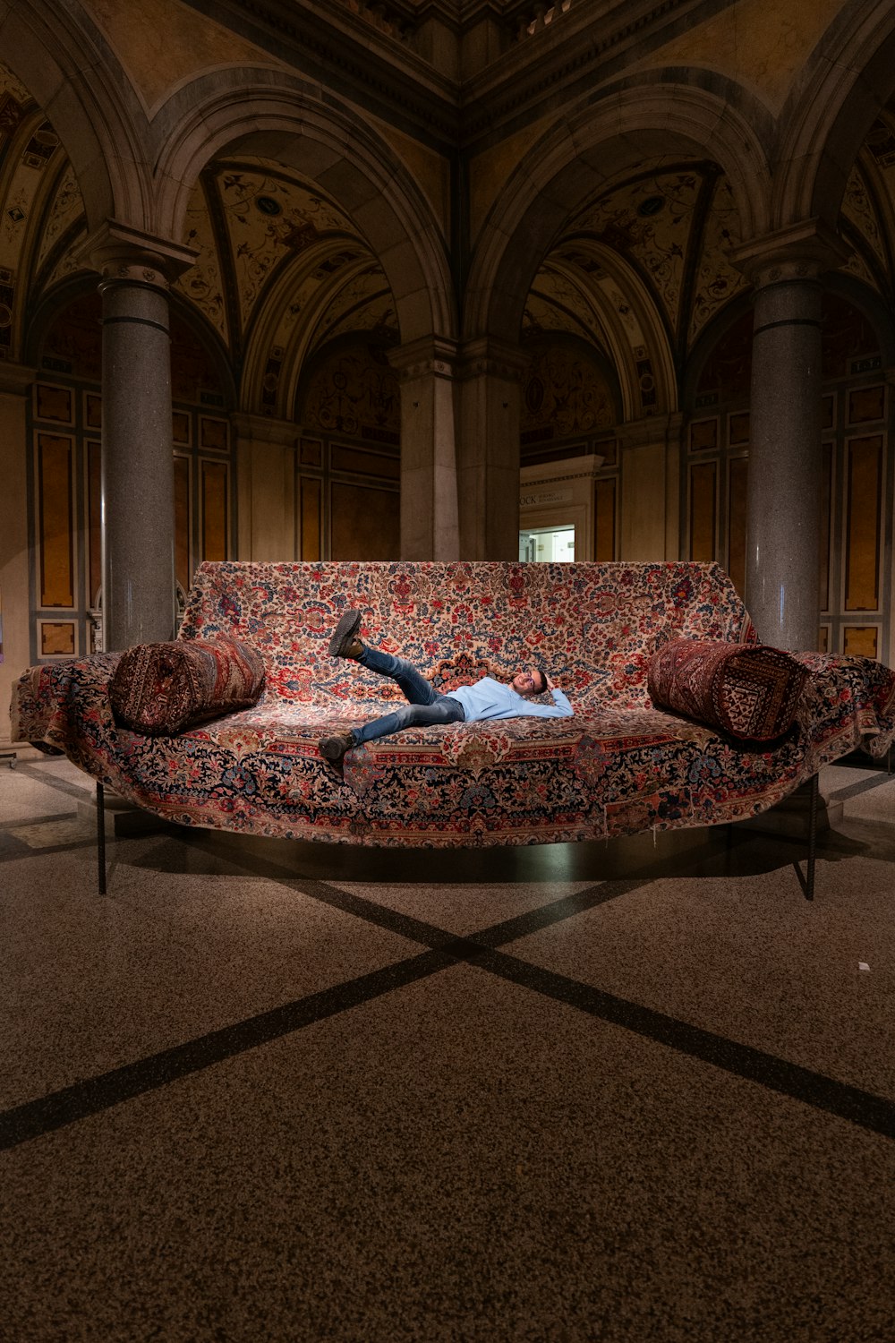 a man laying on top of a couch in a room