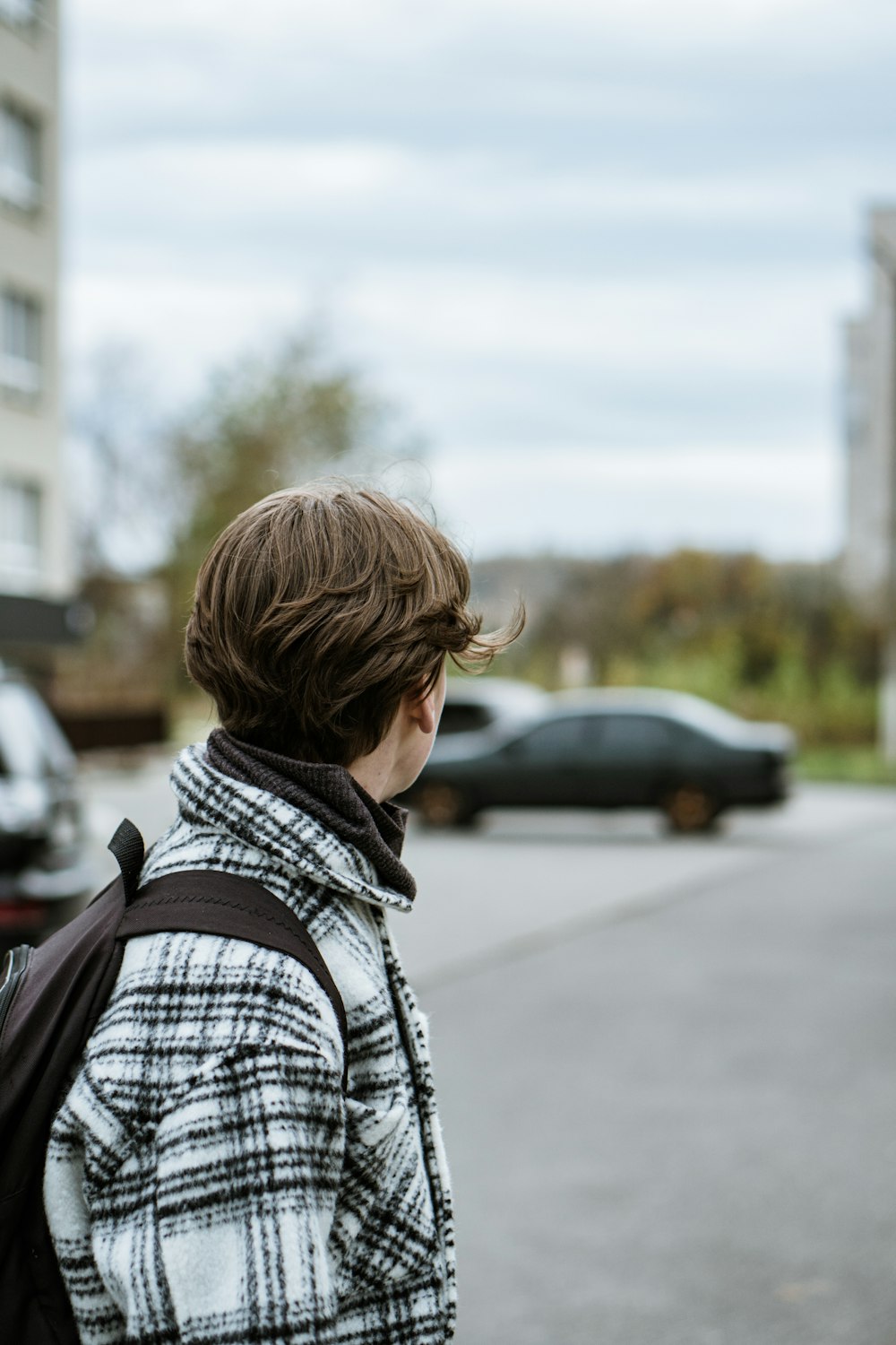 a person walking down a street with a backpack