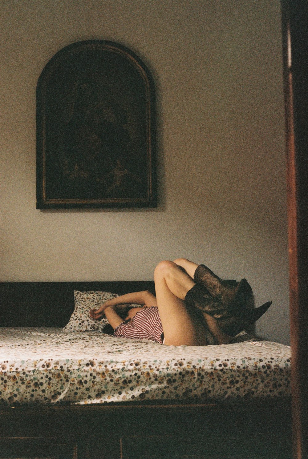 a woman laying on a bed in a room