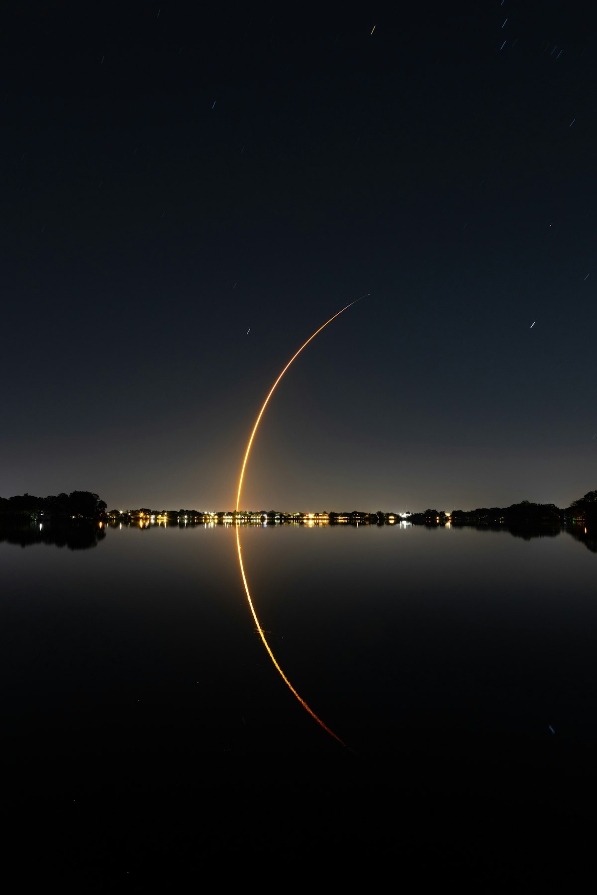 Long exposure photograph of a SpaceX Falcon 9 rocket launch from Florida at night