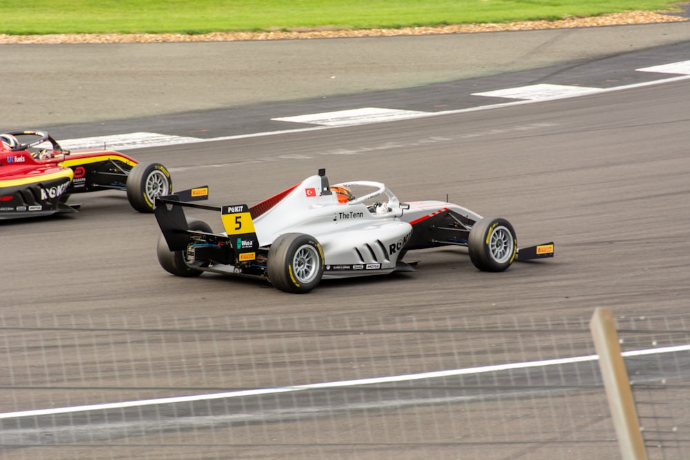 two race cars racing on a race track