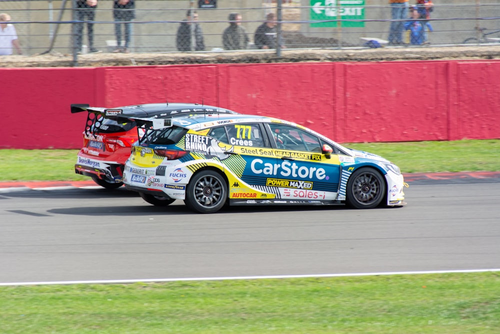 a car driving on a race track with people watching