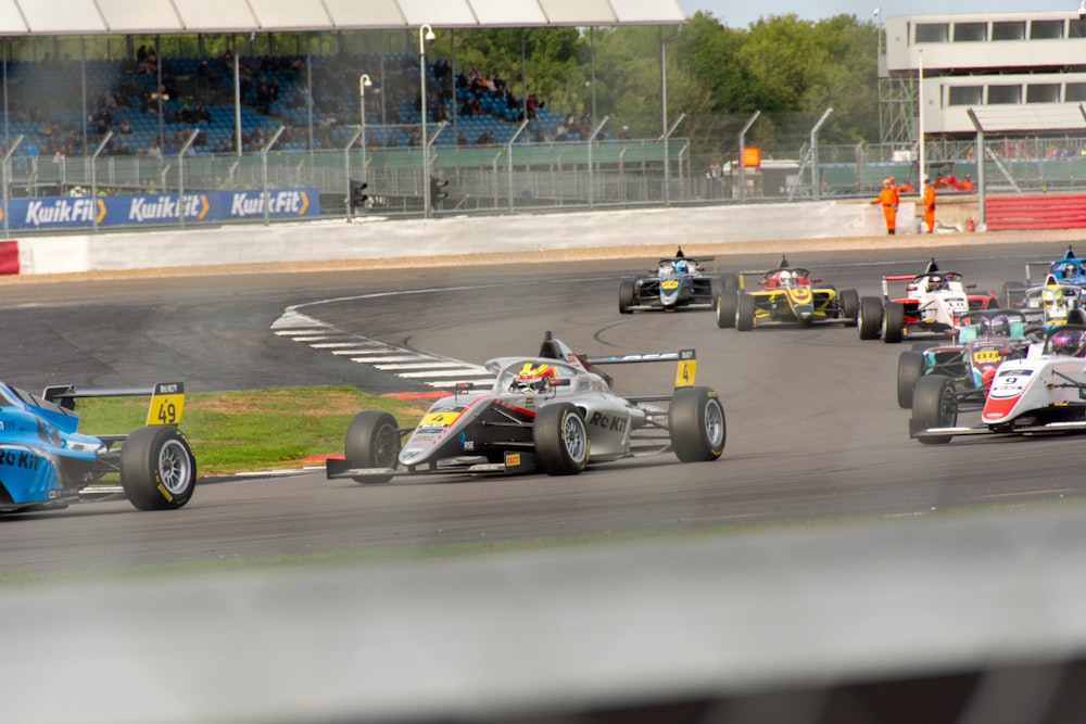 a group of cars racing around a track