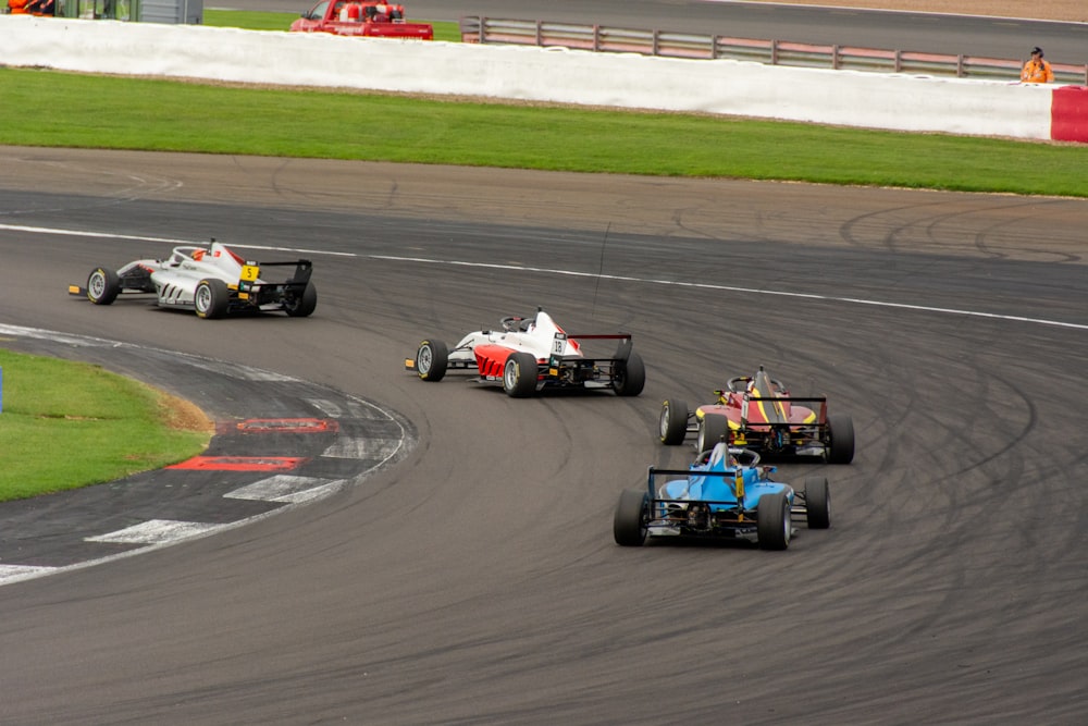 a group of racing cars driving around a track
