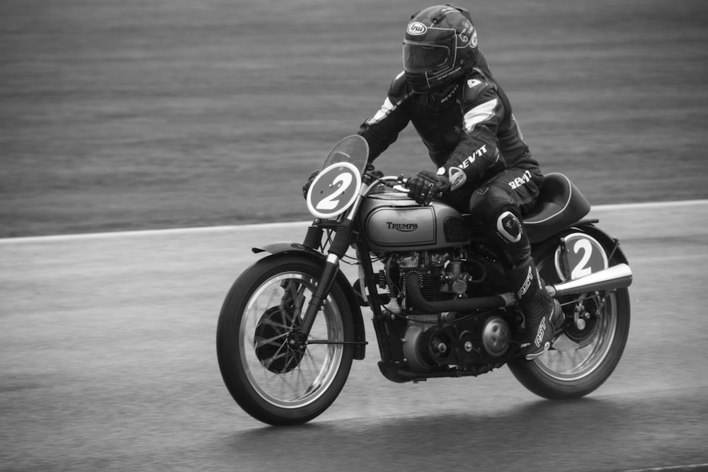 a man riding a motorcycle down a race track