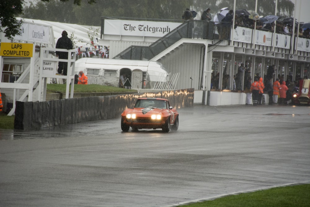 a car driving down a wet road in the rain