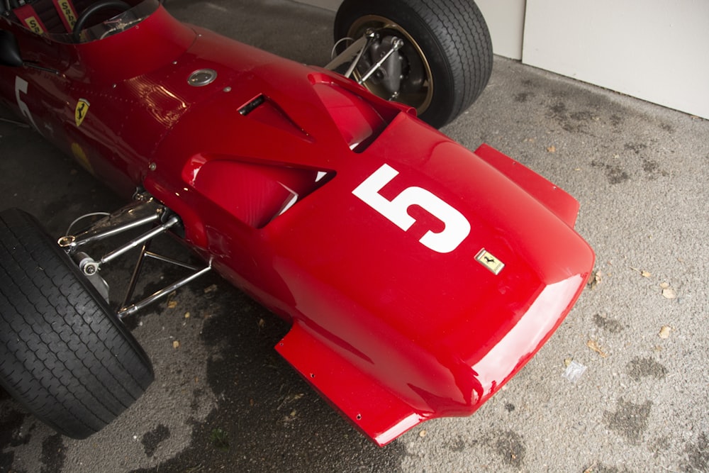 a close up of a red race car on the ground