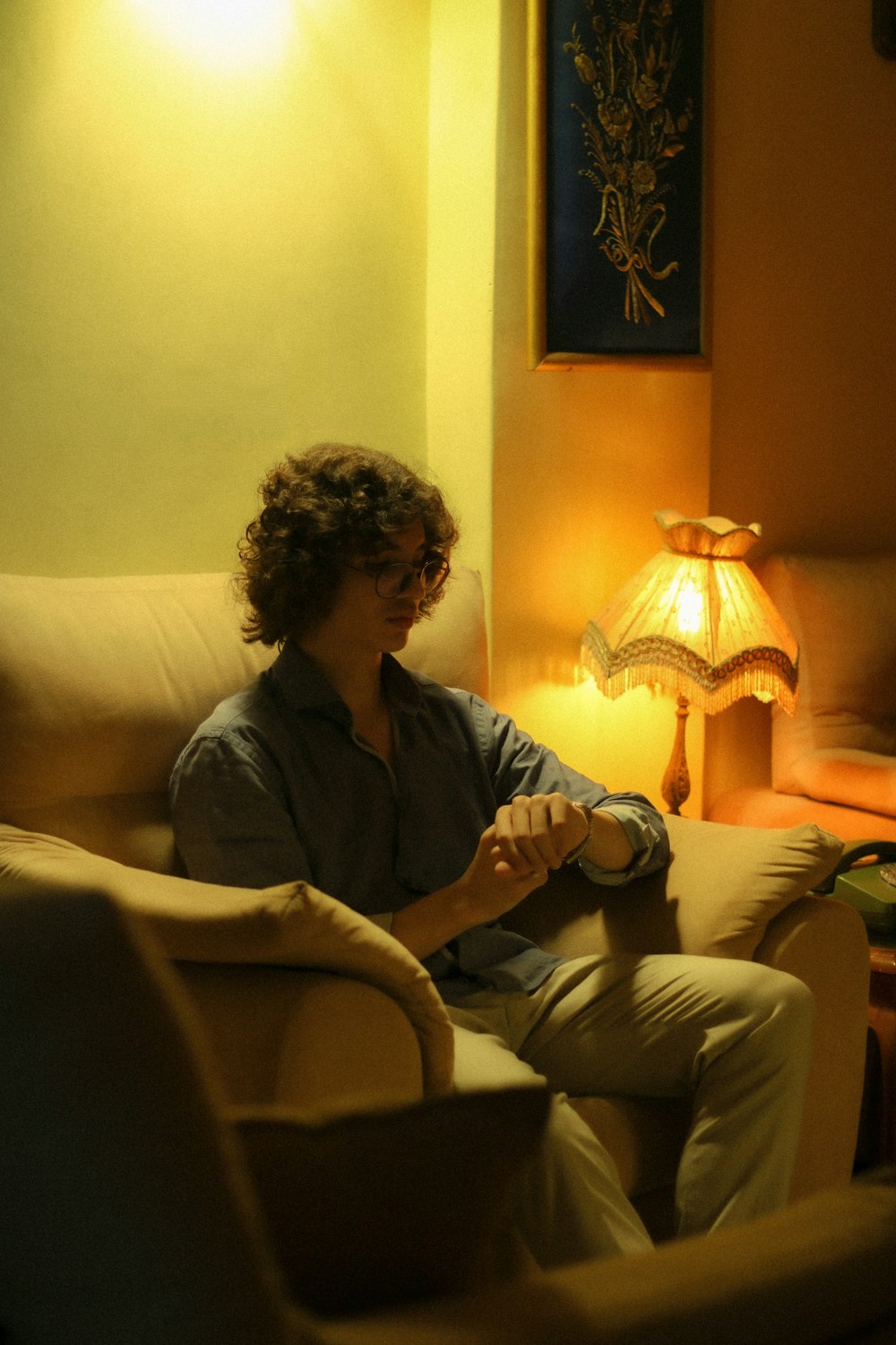 a man sitting on a couch in a living room