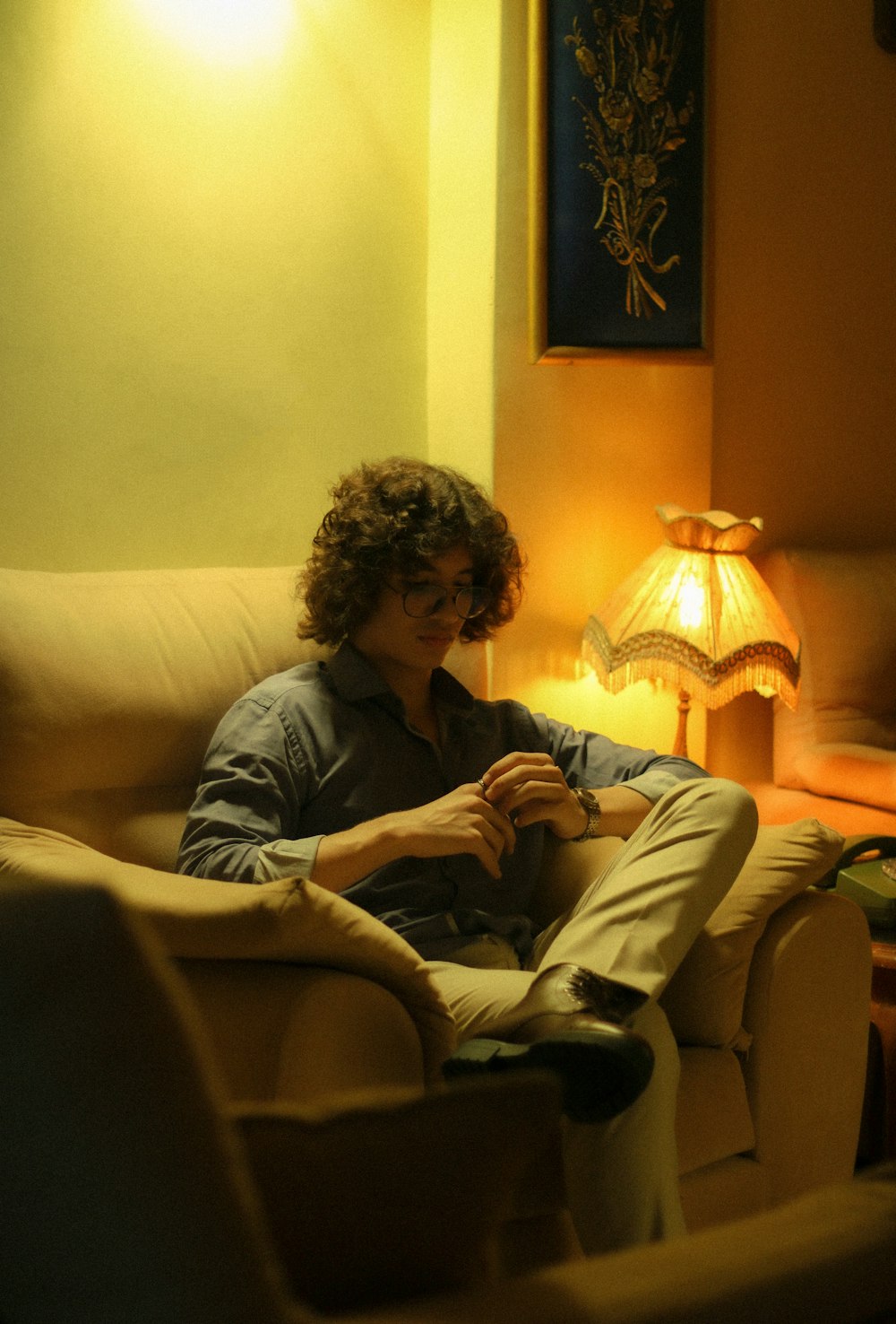 a man sitting on a couch in a living room