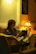Portrait of Luis M. reading a book in a cozy armchair.