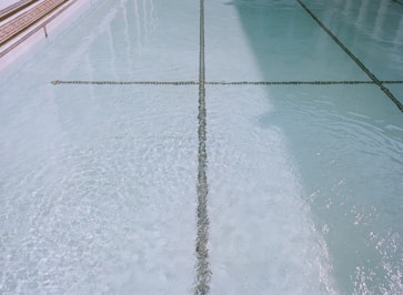 a tiled swimming pool with clear blue water