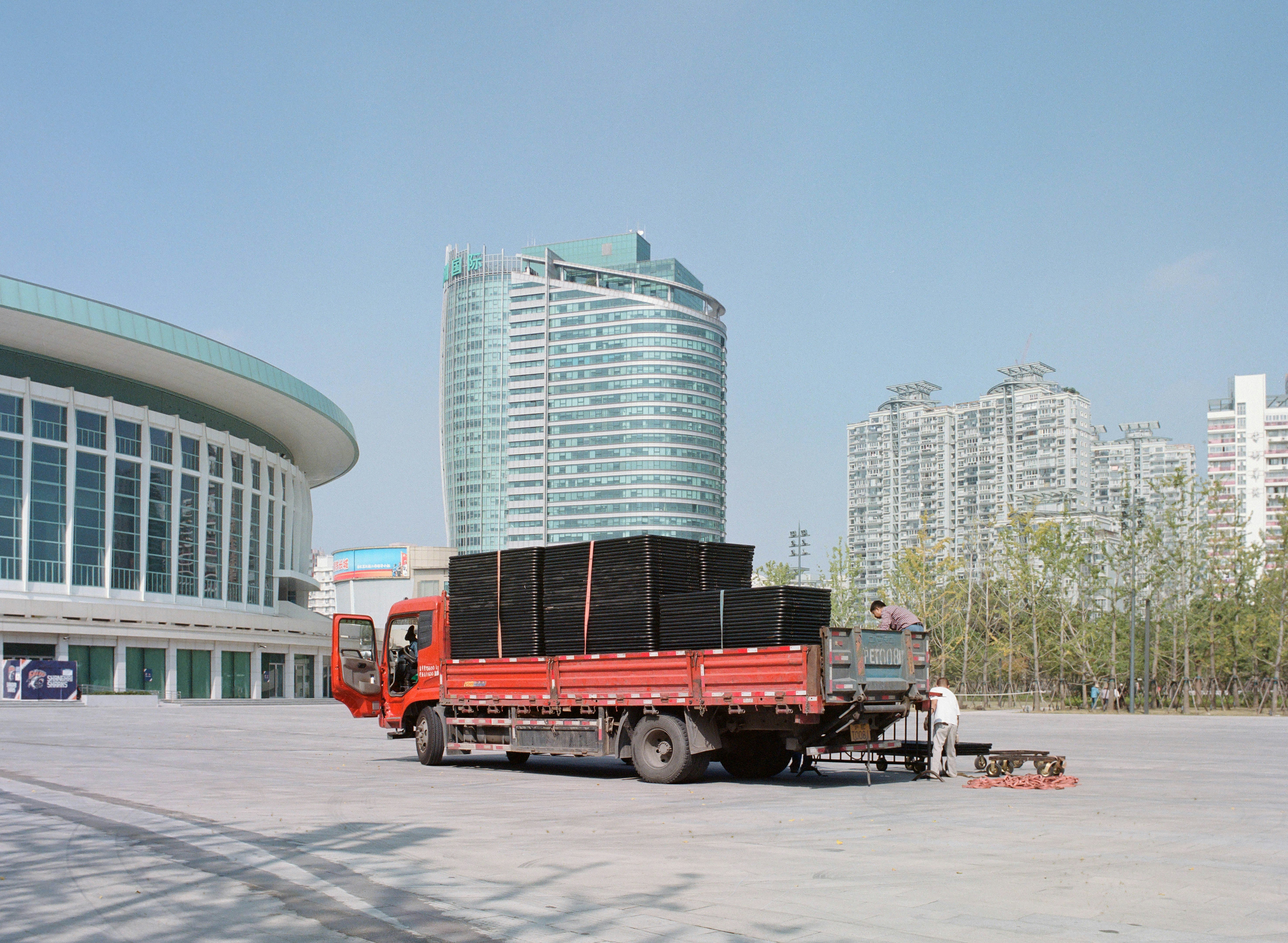 a red truck parked in front of a tall building