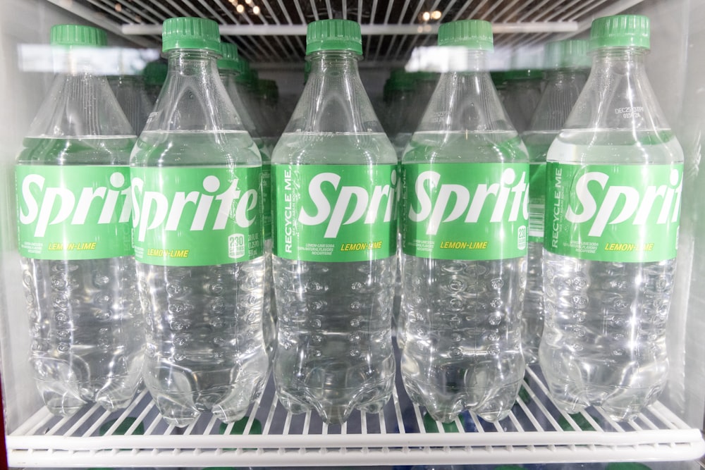 a refrigerator filled with bottles of sprite sprite water