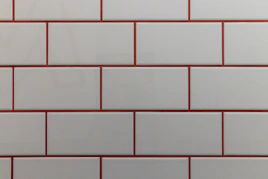 a close up of a white and red brick wall
