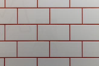 a close up of a white and red brick wall