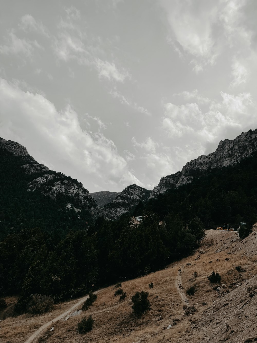 a dirt road going up a hill in the mountains