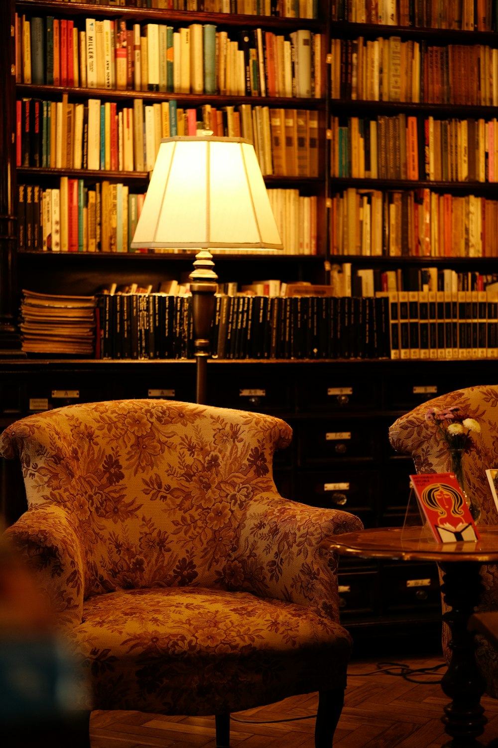 a chair and a table in a room full of books