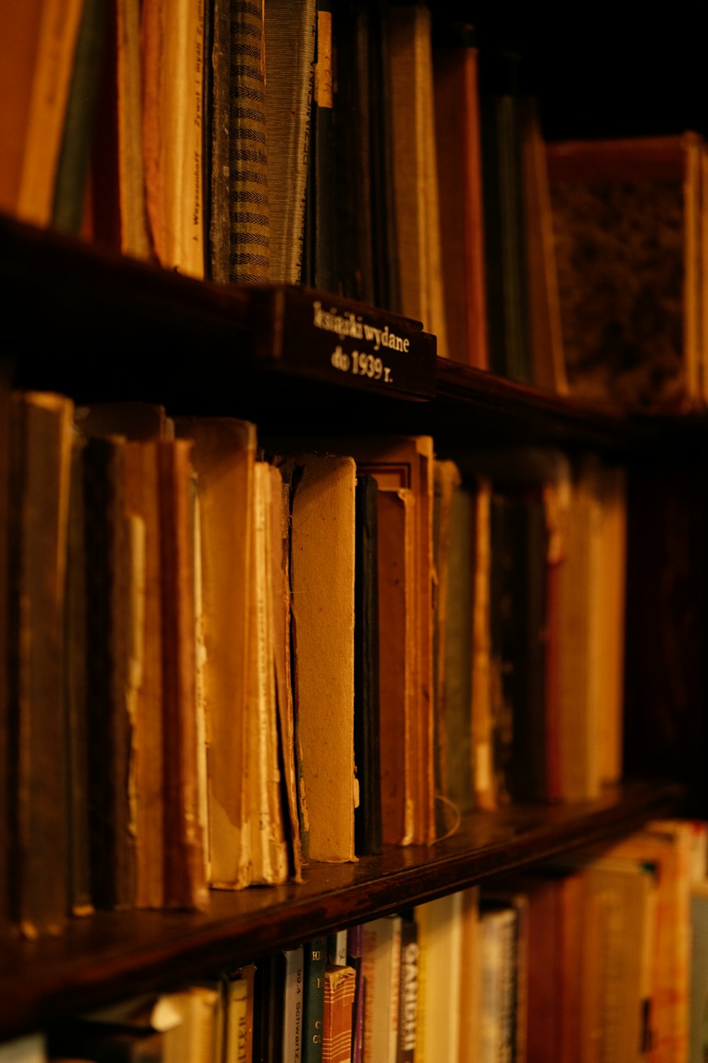 a bookshelf filled with lots of books in a library