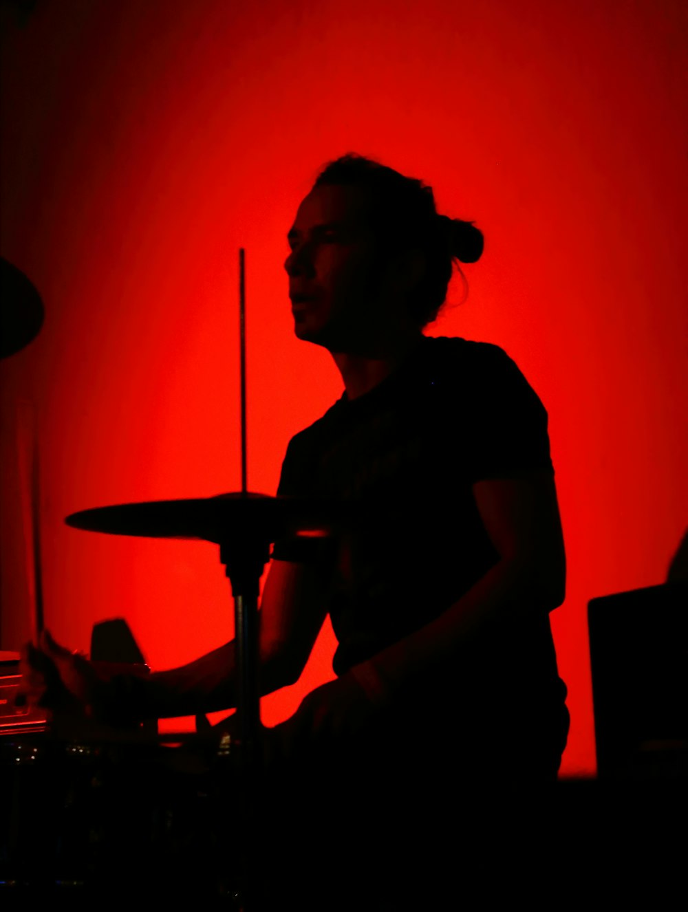 a person sitting in front of a drum set