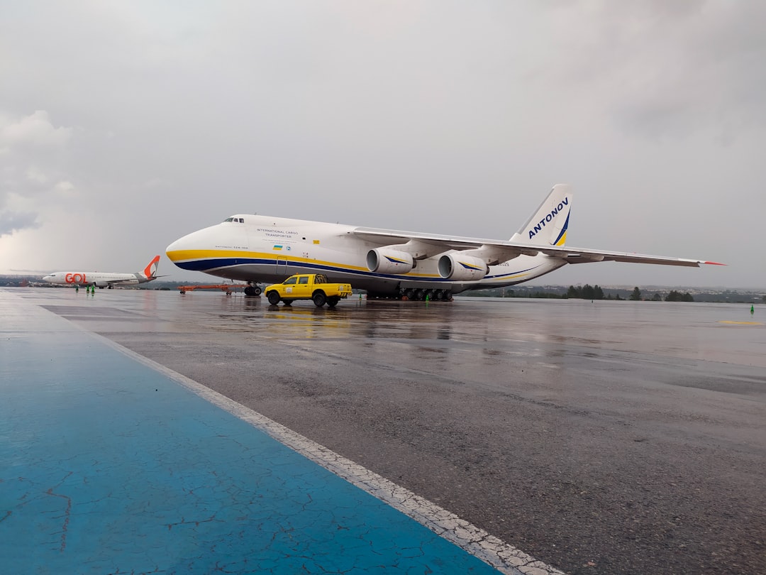 a large jetliner sitting on top of an airport tarmac, ANTONOV 124