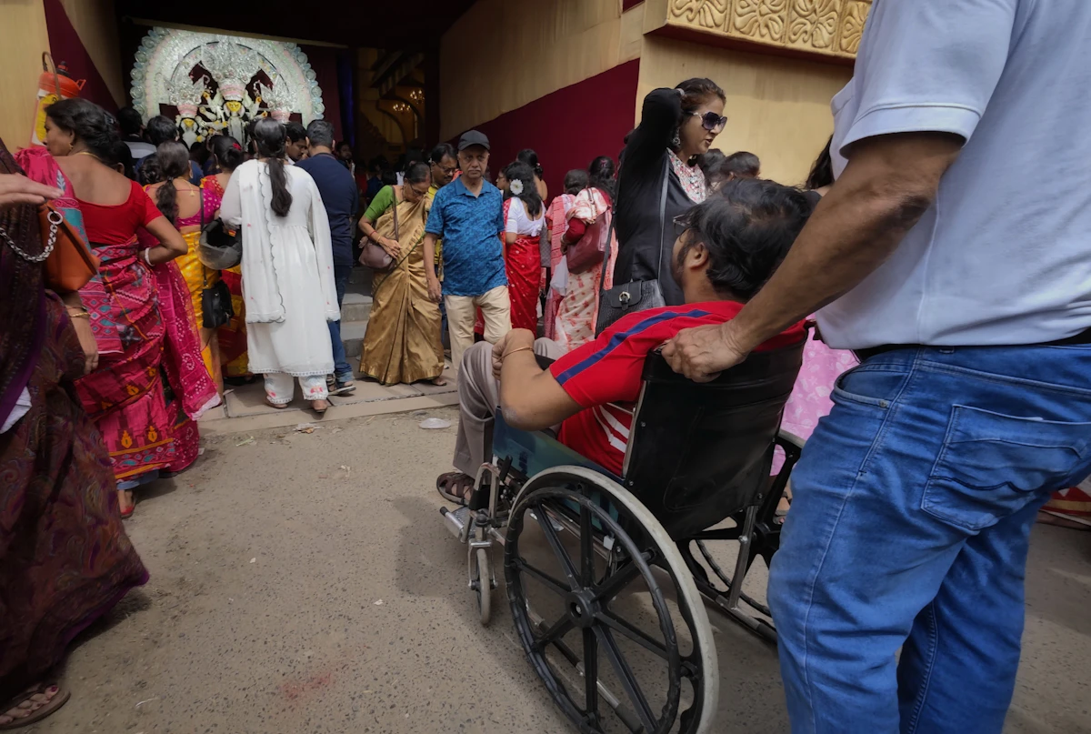 People gathered around a man in a wheelchair