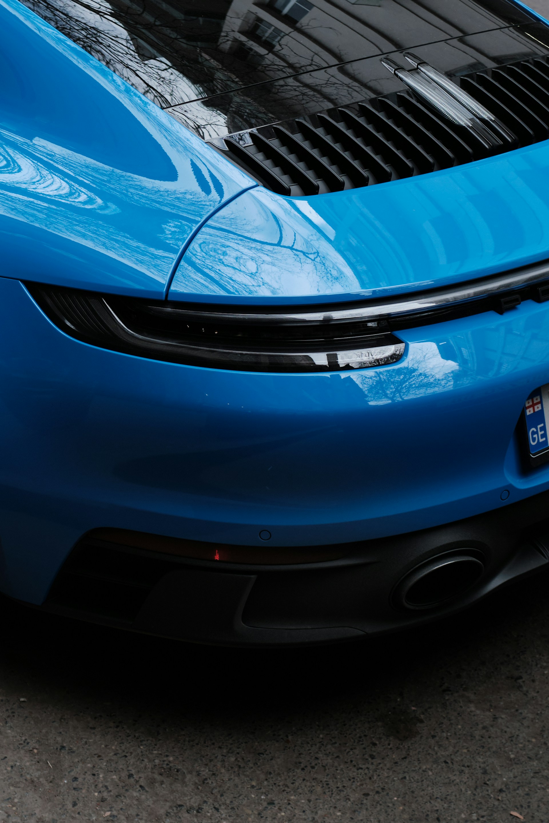 a blue sports car parked on the side of the road