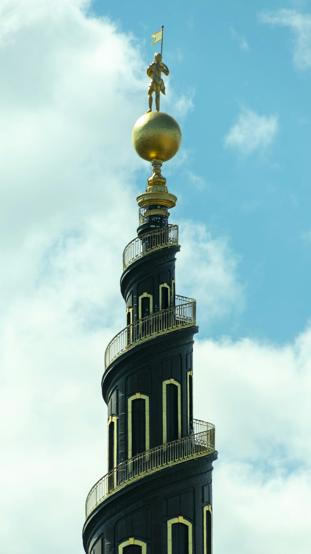 a very tall tower with a golden top