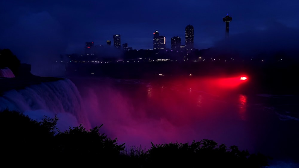 a view of niagara falls at night with the lights on