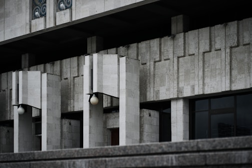 Night view of a brutalist structure illuminated to emphasize its raw concrete form.