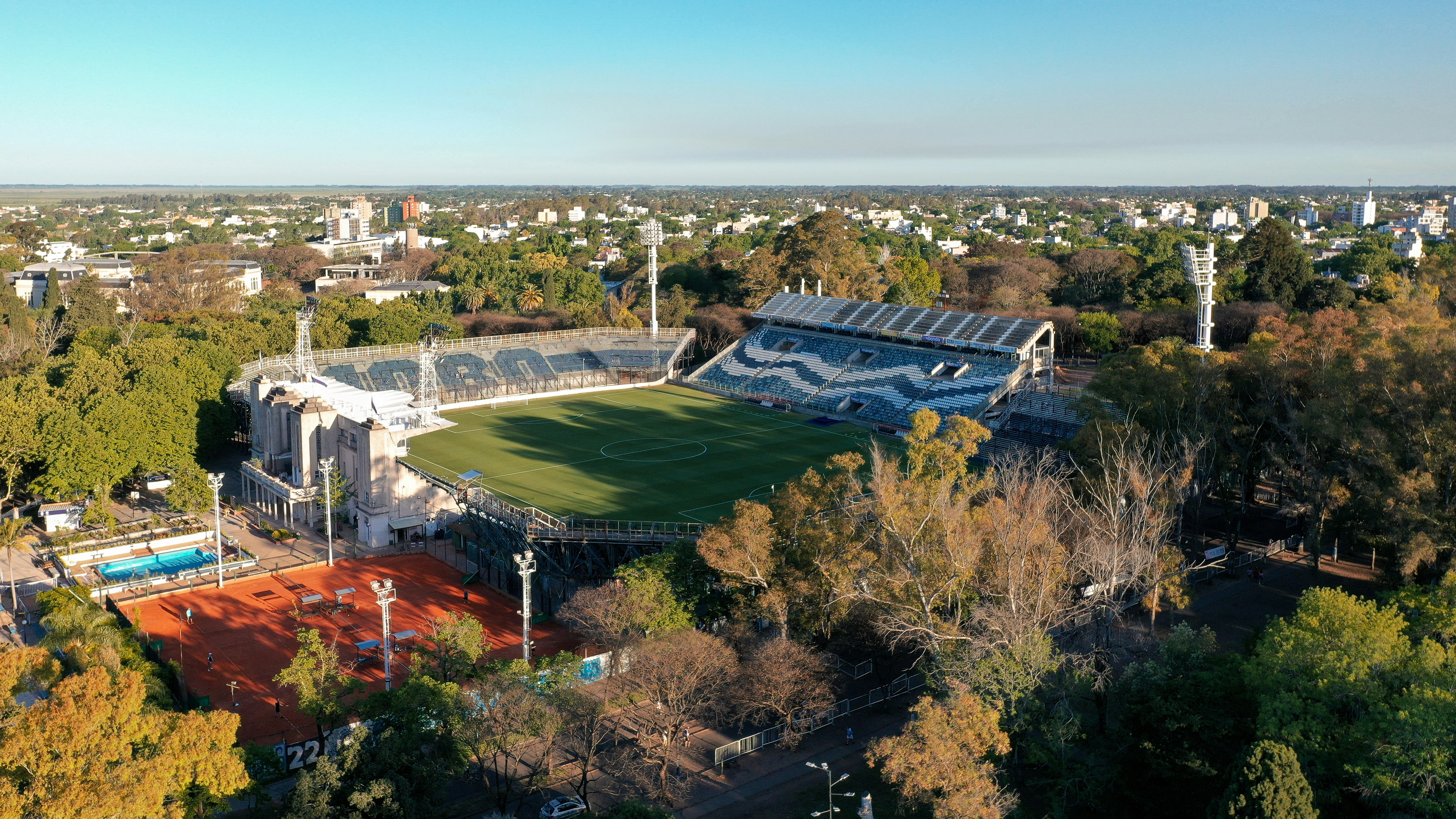 an aerial view of a soccer field surrounded by trees