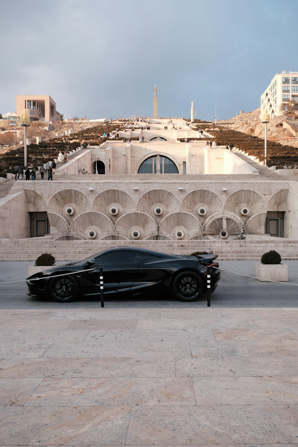 a black sports car parked in front of a building